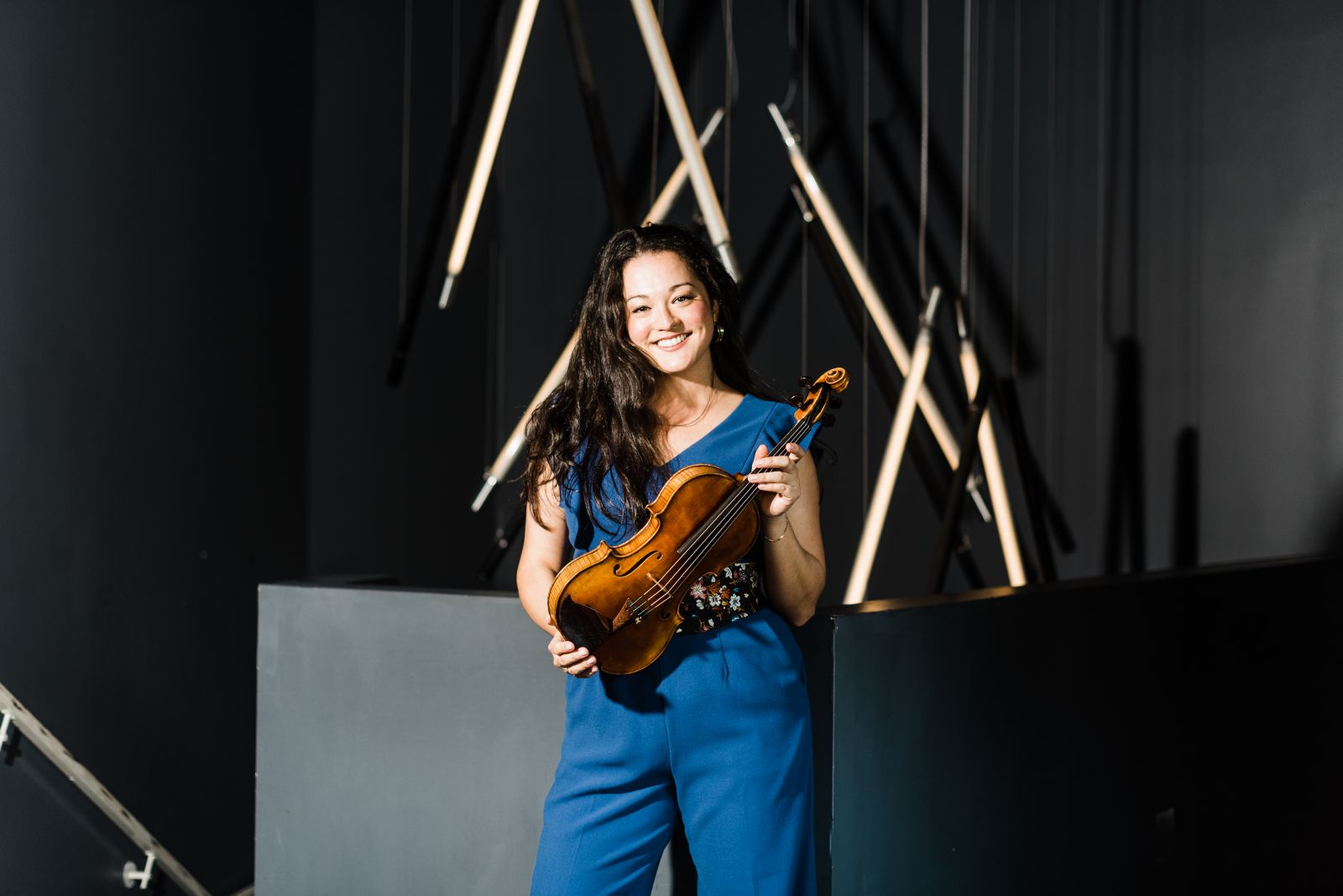 Kumiko Sakamoto smiles while holding her instrument