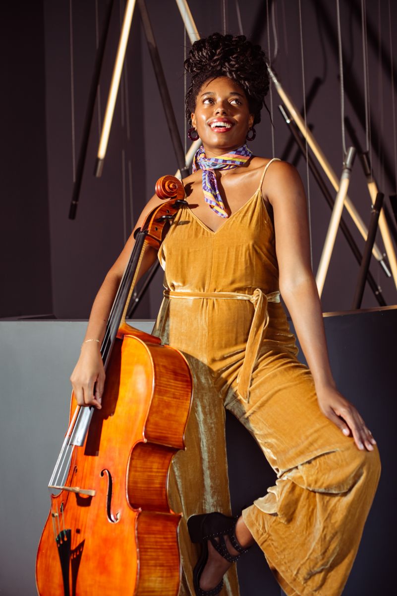 Titilayo Ayangade smiles holding her cello